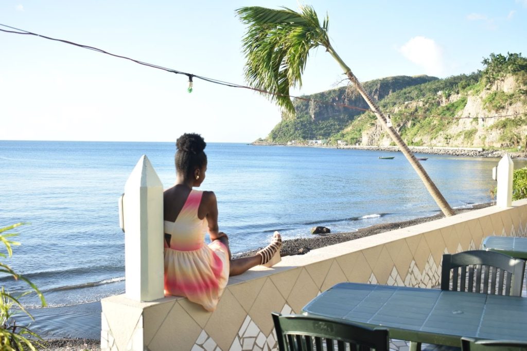 Black girl looking at the beautiful beach in Dominica