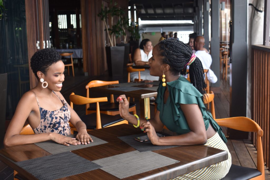 picture of two beautiful black girls chatting at a luxury hotel in the caribbean
