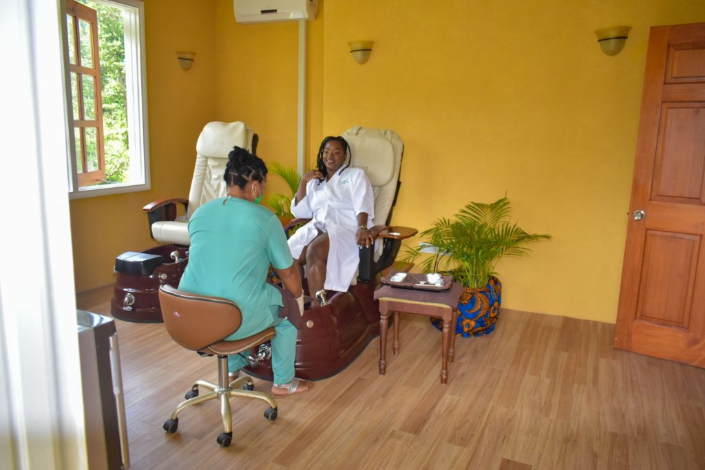 Black girl getting a pedicure at Caribbean resort