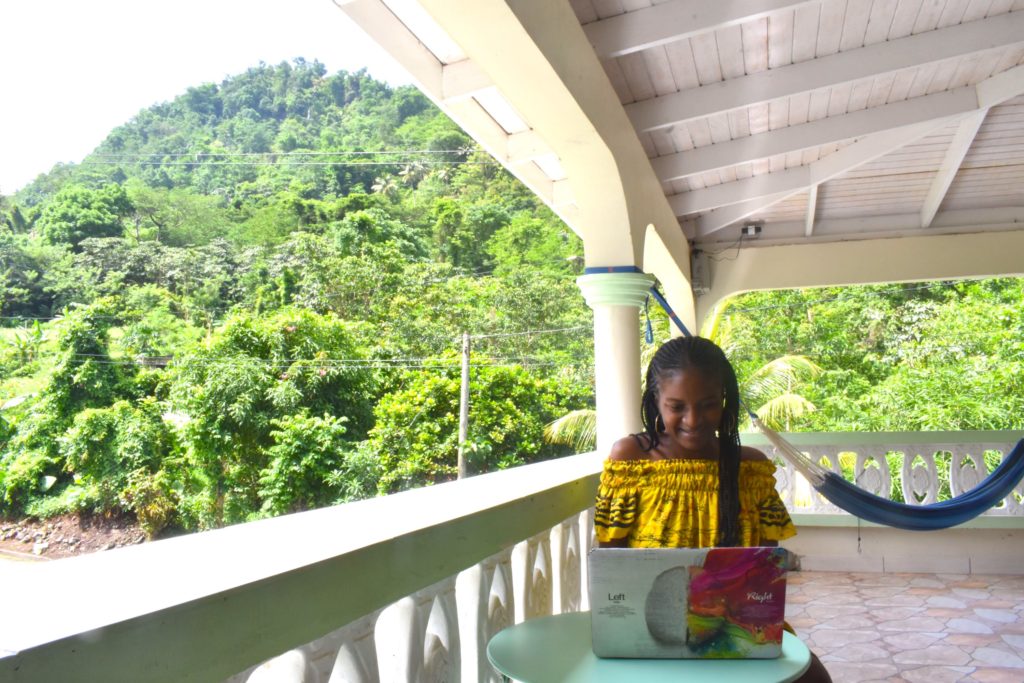 working remotely in dominica black caribbean girl with braids in soufriere