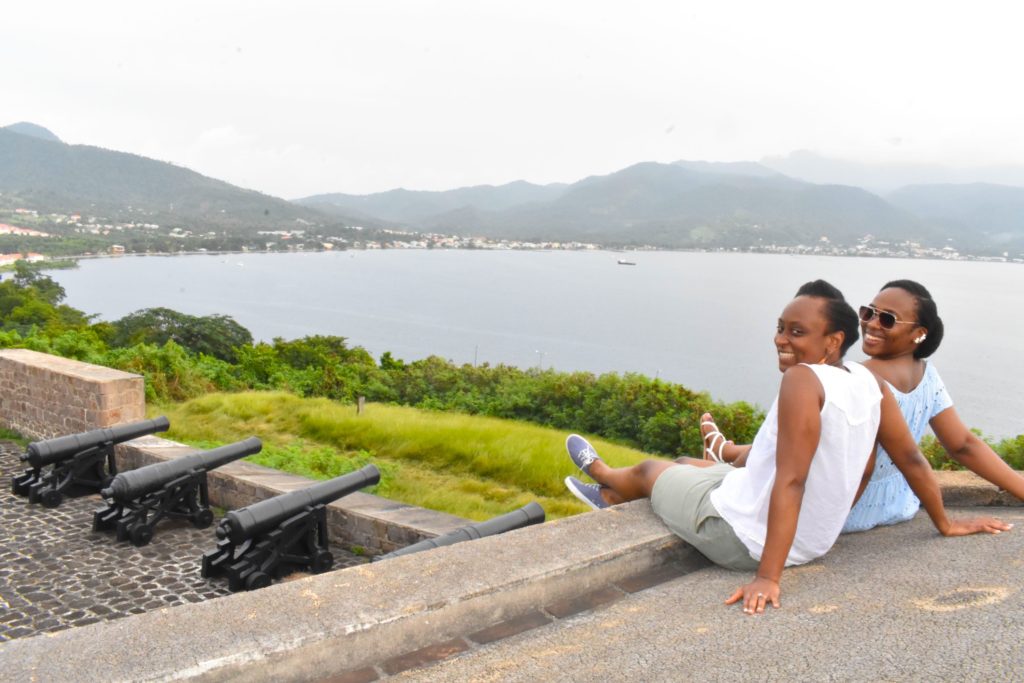 Black girls sitting at Fort Shirley, things to do in dominica
