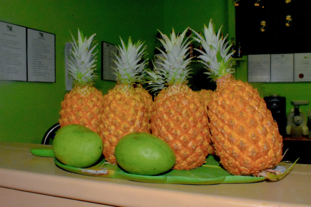 Orange Pineapple and green mango fruit display at Caribbean restaurant for pina colada and fruit cocktails in Dominica, the caribbean - a tropical island cafe