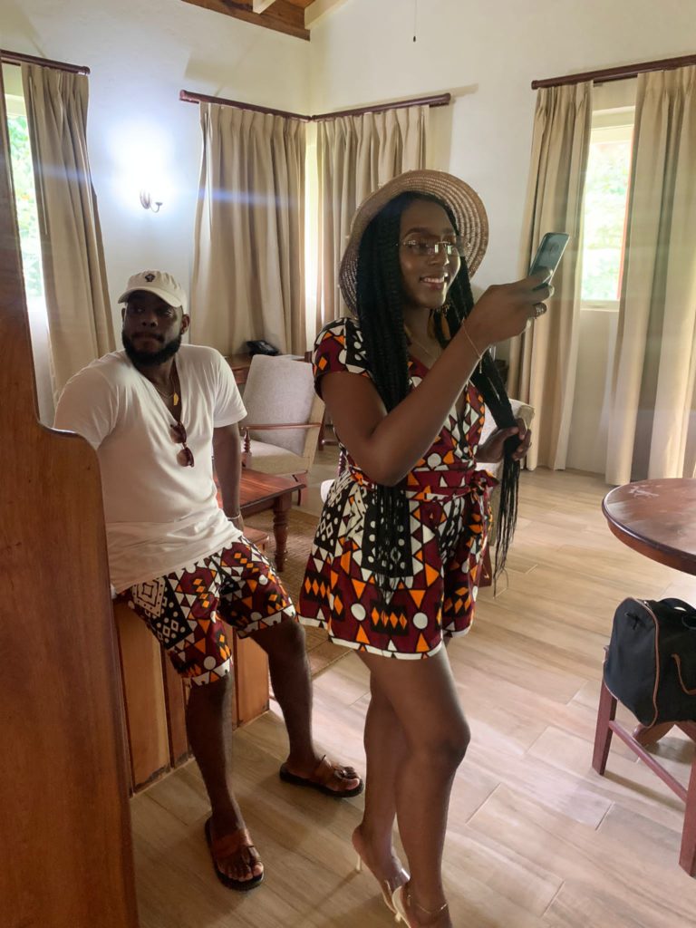 Caribbean eco resort in Dominica: Rosalie bay Ecoresort and Spa. A beautiful girl taking a selfie photo while waiting for her boyfriend - dressed in African print, Ankara bogolan clothing