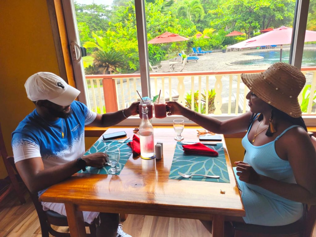 Black couple eating a farm to table lunch at a Caribbean eco-resort - Rosalie Bay Dominica