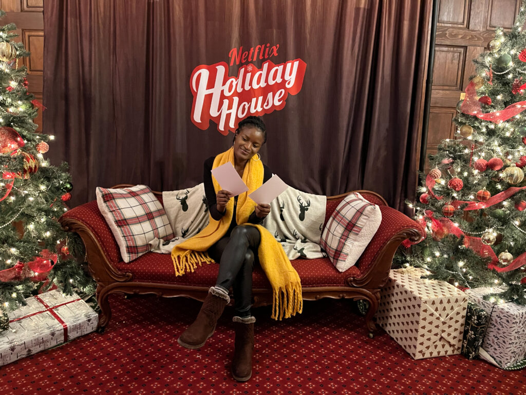  Things to do in Toronto Christmas - Black girl with yellow scarf sitting in a Christmas decorated chair