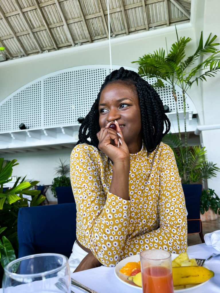 Travel with clem - Black girl eating fruits during a trip to Fairmont Royal Pavilion Barbados