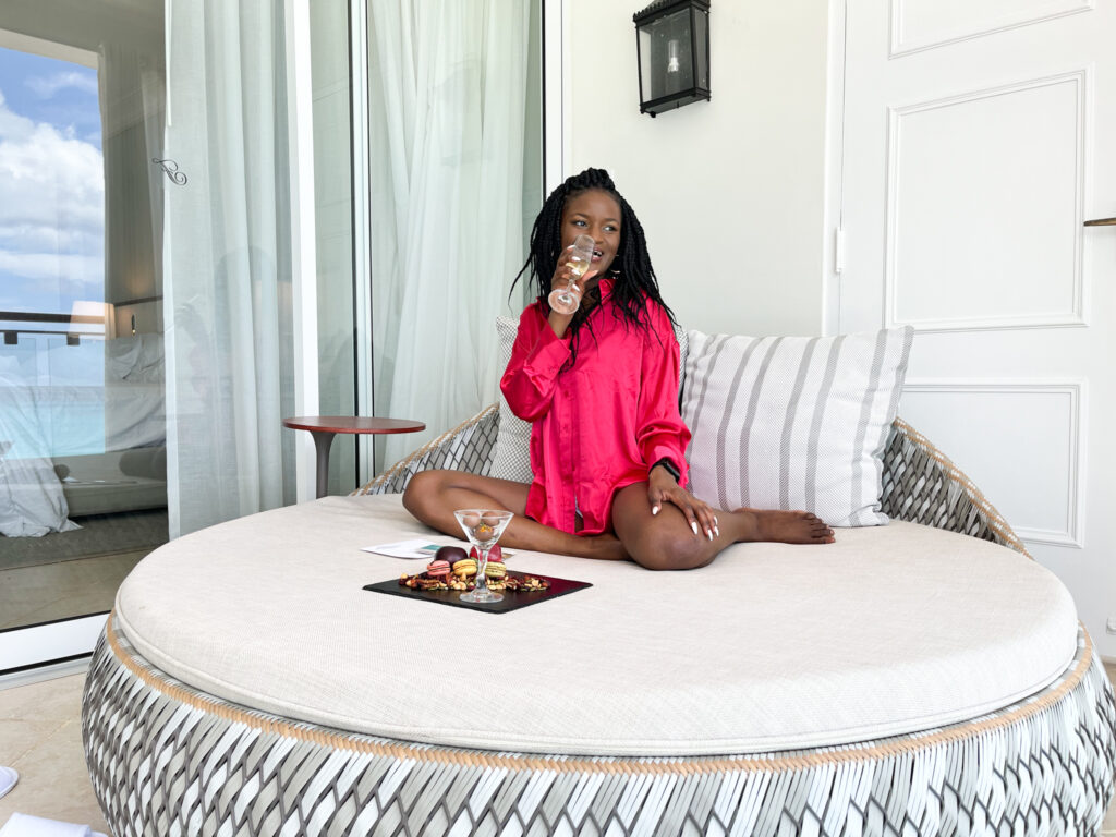 Black girl in red silk blouse enjoying a hotel stay at the Fairmont Barbados