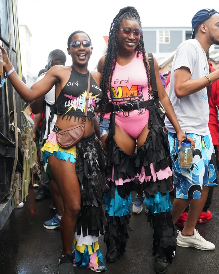 Dominica Carnival - Caribbean Carnival - jouvert morning in Dominica featuring the Lumination by Signal Band - Nicole Morson and Janae Bell wearing body suits