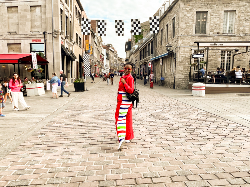 Montreal Travel: beautiful black girl wearing a red and blue pant and red blouse and exploring Old Montreal in Montreal, Quebec - wearing outfits from Ngaska