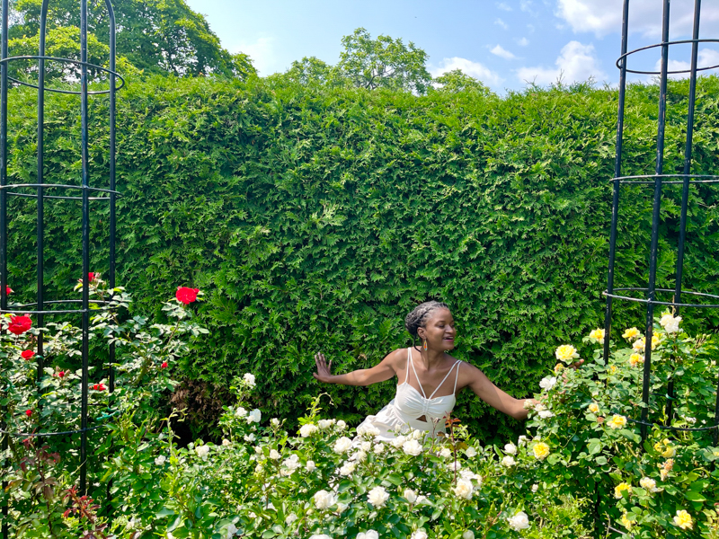 Beautiful Black girl posing at the Montreal Botanical Gardens during a summer visit