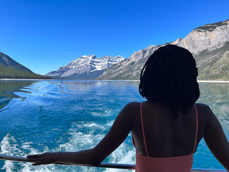 Beautiful black girl overlooking the Lake Minnewanka on a summer day in Banff Canada 