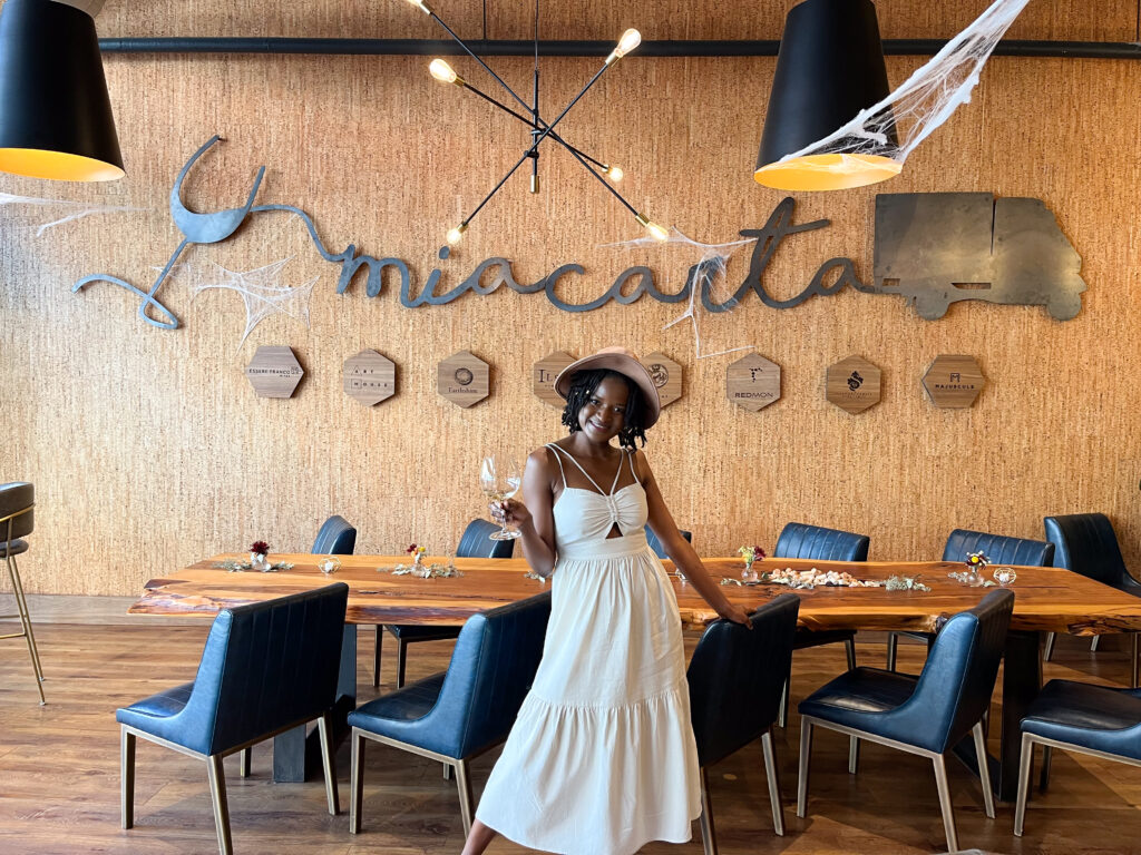 Tasting room downtown Napa: Travel with Clem posing in the Mia Carta wine tasting room downtown Napa
