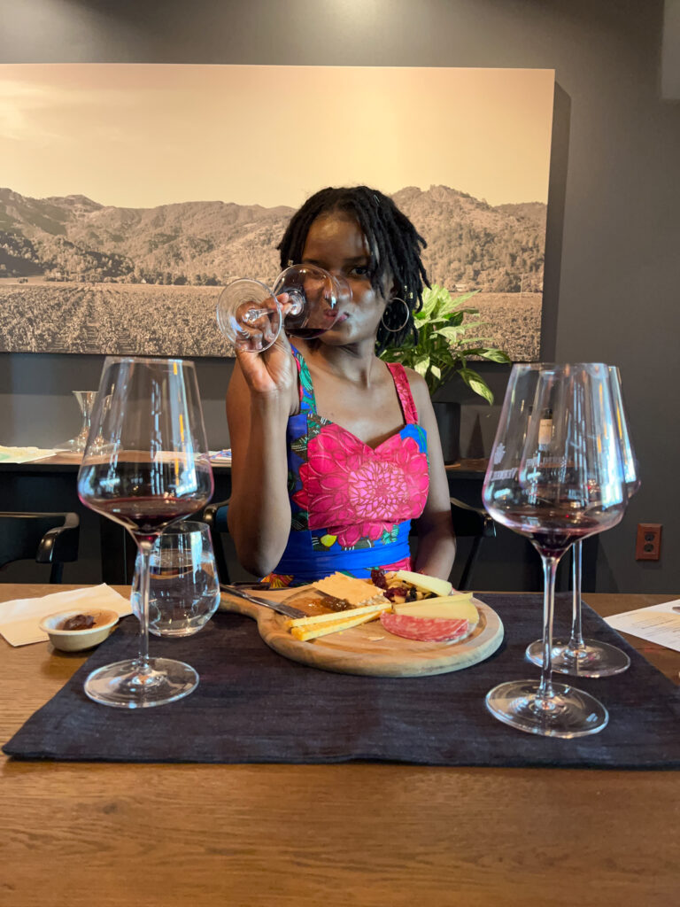 Tasting room downtown Napa: Travel with Clem posing with a glass of wine at the Vermeil Wines Winery Downtown Napa