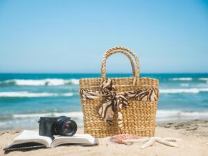 beach bag on the sand - with camera and book