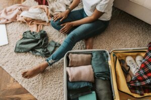 person packing suitcase