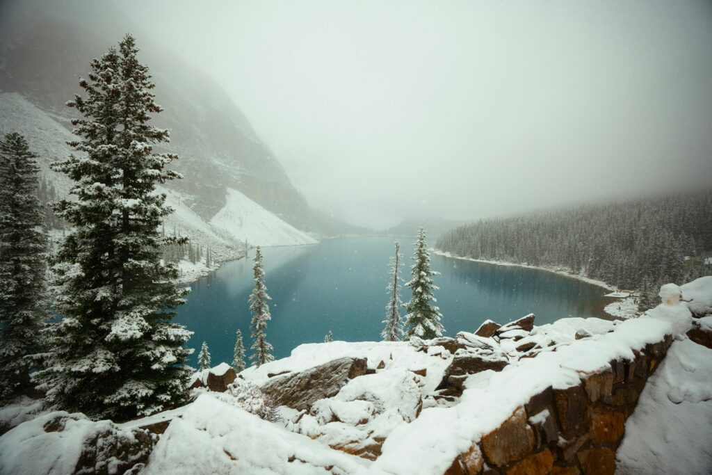 Christmas Bucket List Ideas in Canada - snowy lake moraine or lake louise with snowflakes