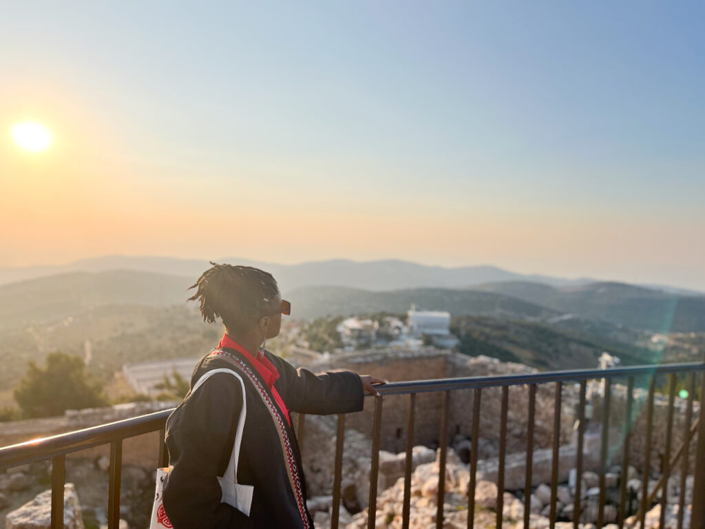 Bible verses about safety - Black woman wearing a bedouin traditional kimono and posing at the Aljoun Castle View Point, Jordan