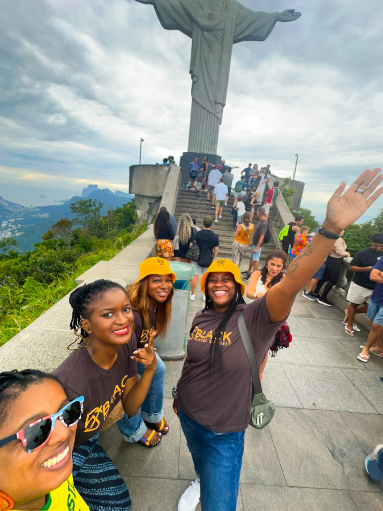 A group of black female travelers visiting Christ the Redeemer in Rio together